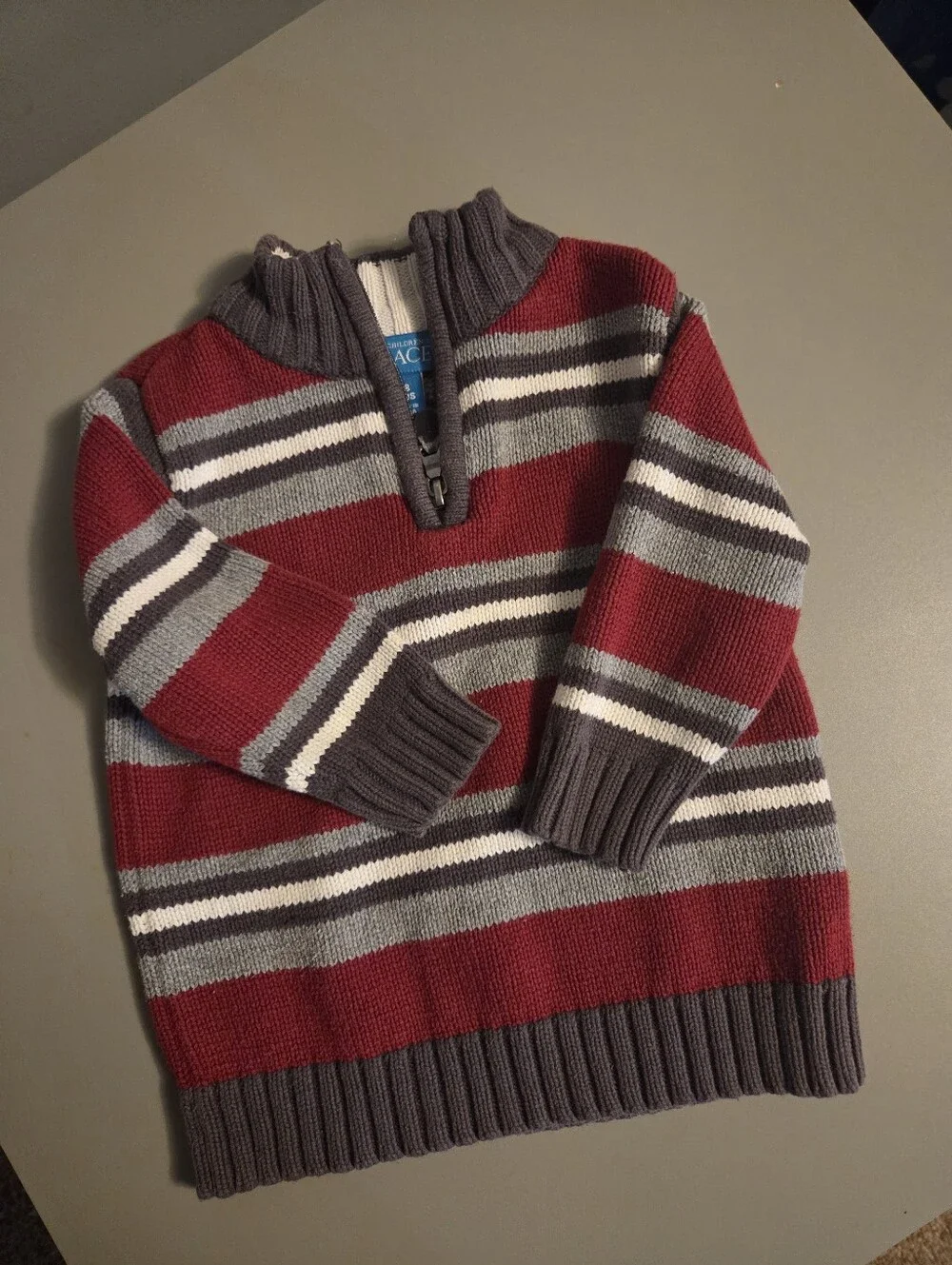 The Childrens Place Boys Striped Quarter-Zip Sweater in Burgundy and Gray.